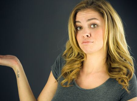 attractive woman on plein background shot in studio with soft lights with an interesting expression and dramatic lightingの写真素材