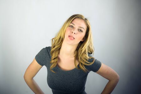 attractive woman on plein background shot in studio with soft lights with an interesting expression and dramatic lightingの写真素材