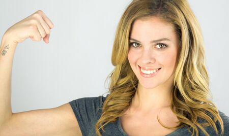 attractive woman on plein background shot in studio with soft lights with an interesting expression and dramatic lightingの写真素材