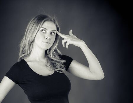 attractive woman on plein background shot in studio with soft lights with an interesting expression and dramatic lighting Black And White, b&wの写真素材