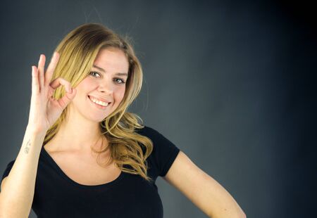 attractive woman on plein background shot in studio with soft lights with an interesting expression and dramatic lightingの写真素材