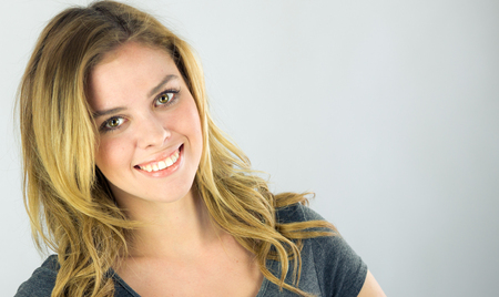 attractive woman on plein background shot in studio with soft lights with an interesting expression and dramatic lightingの写真素材
