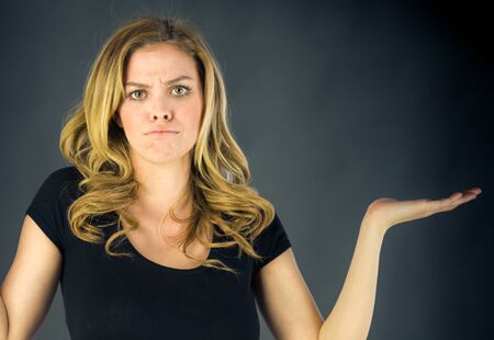 attractive woman on plein background shot in studio with soft lights with an interesting expression and dramatic lightingの写真素材