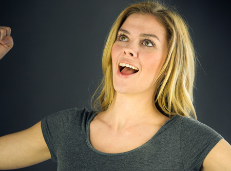 attractive woman on plein background shot in studio with soft lights with an interesting expression and dramatic lightingの写真素材