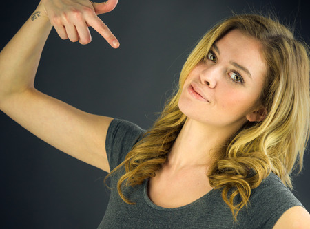attractive woman on plein background shot in studio with soft lights with an interesting expression and dramatic lightingの写真素材