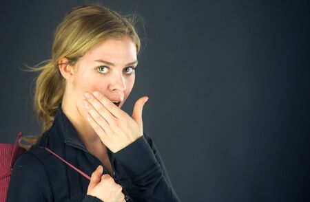 attractive woman on plein background shot in studio with soft lights with an interesting expression and dramatic lightingの写真素材