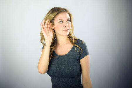 attractive woman on plein background shot in studio with soft lights with an interesting expression and dramatic lightingの写真素材