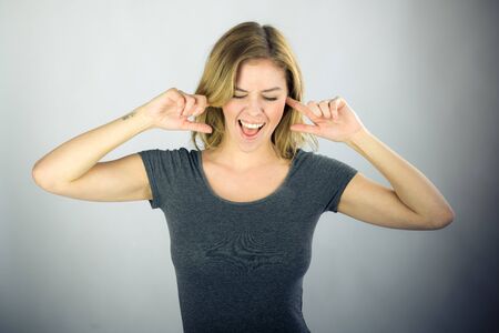 attractive woman on plein background shot in studio with soft lights with an interesting expression and dramatic lightingの写真素材