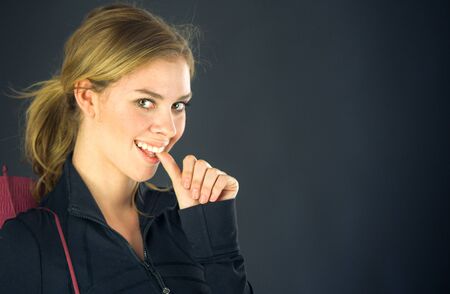 attractive woman on plein background shot in studio with soft lights with an interesting expression and dramatic lightingの写真素材