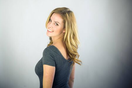 attractive woman on plein background shot in studio with soft lights with an interesting expression and dramatic lightingの写真素材