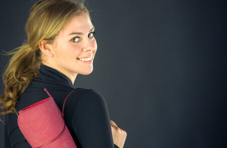 attractive woman on plein background shot in studio with soft lights with an interesting expression and dramatic lightingの写真素材