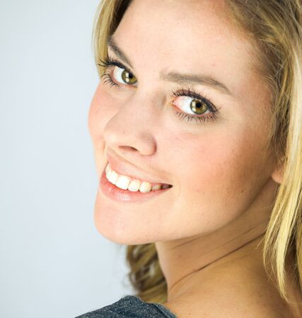 attractive woman on plein background shot in studio with soft lights with an interesting expression and dramatic lightingの写真素材