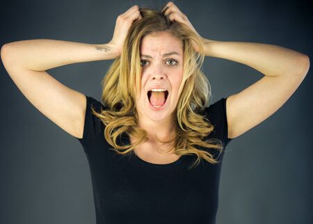 attractive woman on plein background shot in studio with soft lights with an interesting expression...