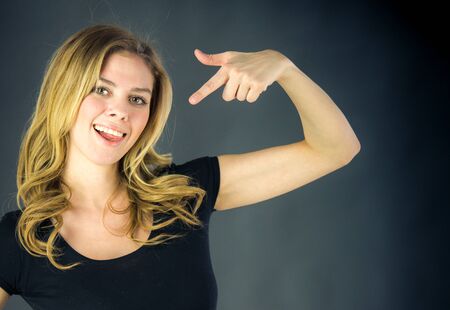 attractive woman on plein background shot in studio with soft lights with an interesting expression and dramatic lightingの写真素材