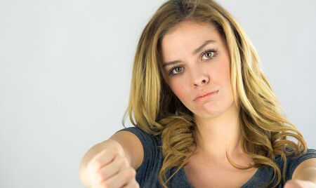 attractive woman on plein background shot in studio with soft lights with an interesting expression and dramatic lightingの写真素材