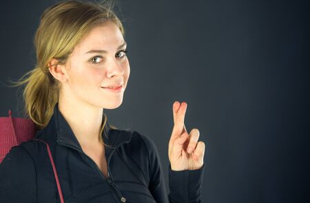 attractive woman on plein background shot in studio with soft lights with an interesting expression and dramatic lightingの写真素材