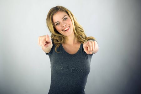 attractive woman on plein background shot in studio with soft lights with an interesting expression and dramatic lightingの写真素材