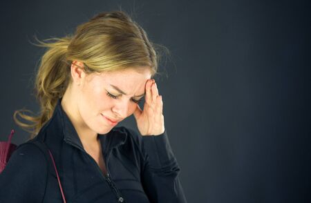 attractive woman on plein background shot in studio with soft lights with an interesting expression and dramatic lightingの写真素材