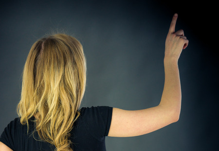attractive woman on plein background shot in studio with soft lights with an interesting expression and dramatic lightingの写真素材