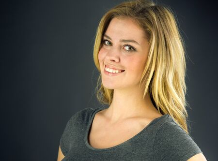 attractive woman on plein background shot in studio with soft lights with an interesting expression and dramatic lightingの写真素材