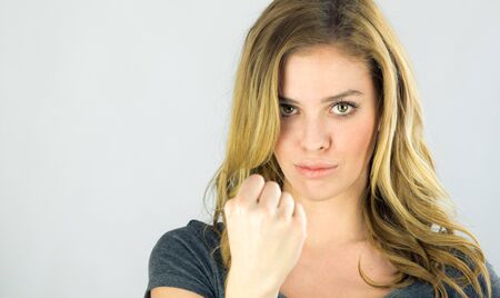 attractive woman on plein background shot in studio with soft lights with an interesting expression and dramatic lightingの写真素材