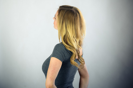 attractive woman on plein background shot in studio with soft lights with an interesting expression and dramatic lightingの写真素材