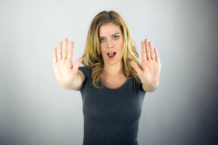 attractive woman on plein background shot in studio with soft lights with an interesting expression and dramatic lightingの写真素材