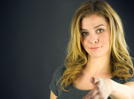 attractive woman on plein background shot in studio with soft lights with an interesting expression and dramatic lightingの写真素材