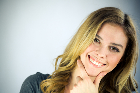 attractive woman on plein background shot in studio with soft lights with an interesting expression and dramatic lightingの写真素材