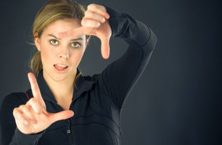 attractive woman on plein background shot in studio with soft lights with an interesting expression and dramatic lightingの写真素材