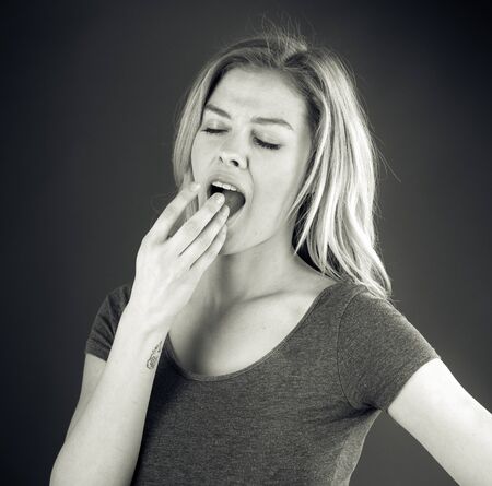 attractive woman on plein background shot in studio with soft lights with an interesting expression and dramatic lighting Black And White, b&wの写真素材