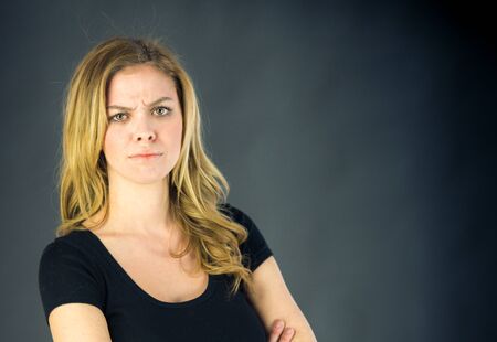 attractive woman on plein background shot in studio with soft lights with an interesting expression and dramatic lightingの写真素材