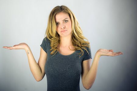 attractive woman on plein background shot in studio with soft lights with an interesting expression and dramatic lightingの写真素材