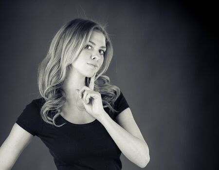 attractive woman on plein background shot in studio with soft lights with an interesting expression and dramatic lighting Black And White, b&wの写真素材