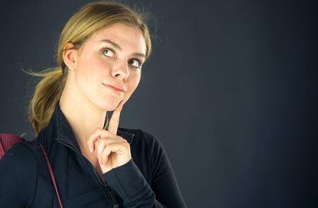 attractive woman on plein background shot in studio with soft lights with an interesting expression and dramatic lightingの写真素材