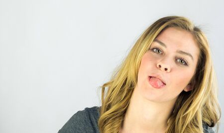 attractive woman on plein background shot in studio with soft lights with an interesting expression and dramatic lightingの写真素材