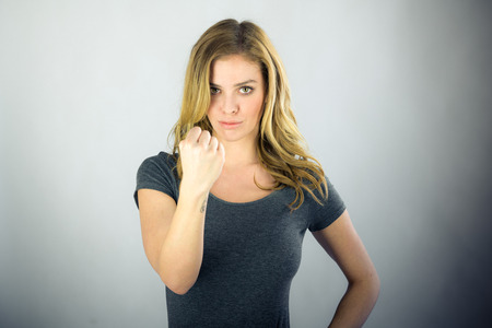 attractive woman on plein background shot in studio with soft lights with an interesting expression and dramatic lightingの写真素材