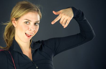 attractive woman on plein background shot in studio with soft lights with an interesting expression and dramatic lightingの写真素材