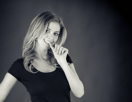 attractive woman on plein background shot in studio with soft lights with an interesting expression and dramatic lighting Black And White, b&wの写真素材