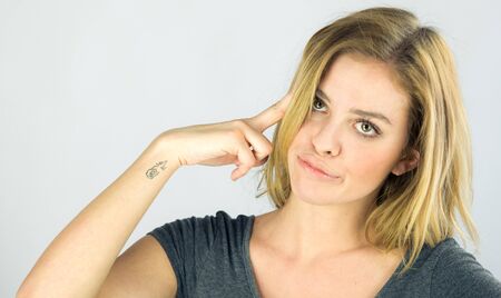 attractive woman on plein background shot in studio with soft lights with an interesting expression and dramatic lightingの写真素材