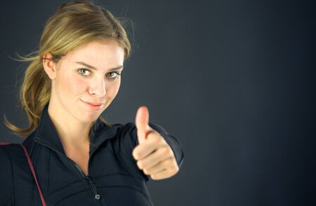 attractive woman on plein background shot in studio with soft lights with an interesting expression and dramatic lightingの写真素材