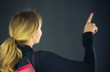 attractive woman on plein background shot in studio with soft lights with an interesting expression and dramatic lightingの写真素材