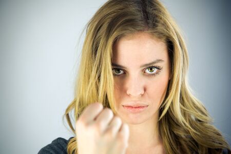attractive woman on plein background shot in studio with soft lights with an interesting expression and dramatic lightingの写真素材