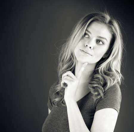 attractive woman on plein background shot in studio with soft lights with an interesting expression and dramatic lighting Black And White, b&wの写真素材