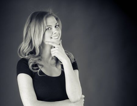 attractive woman on plein background shot in studio with soft lights with an interesting expression and dramatic lighting Black And White, b&wの写真素材