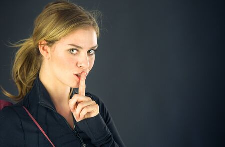 attractive woman on plein background shot in studio with soft lights with an interesting expression and dramatic lightingの写真素材