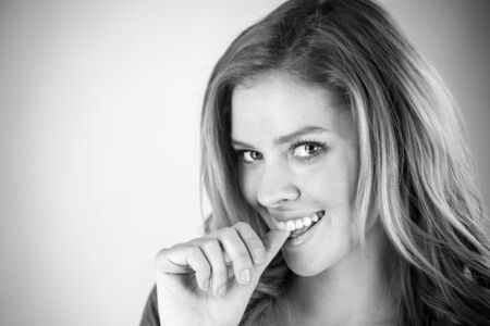 attractive woman on plein background shot in studio with soft lights with an interesting expression and dramatic lighting Black And White, b&wの写真素材