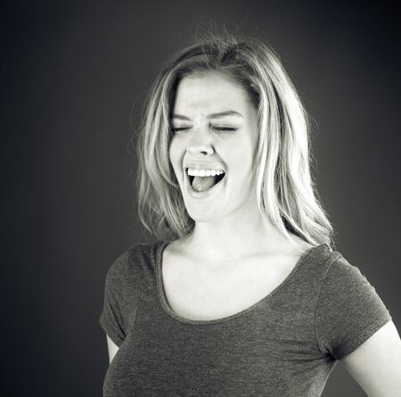 attractive woman on plein background shot in studio with soft lights with an interesting expression and dramatic lighting Black And White, b&wの写真素材