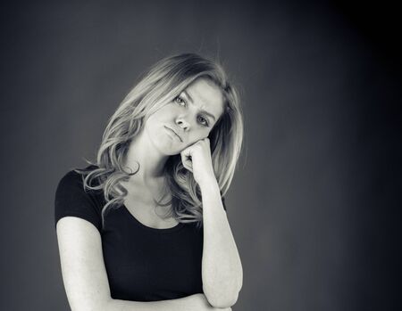 attractive woman on plein background shot in studio with soft lights with an interesting expression and dramatic lighting Black And White, b&wの写真素材