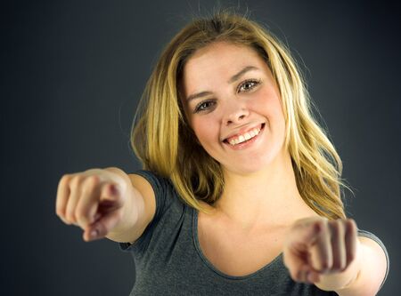 attractive woman on plein background shot in studio with soft lights with an interesting expression and dramatic lightingの写真素材